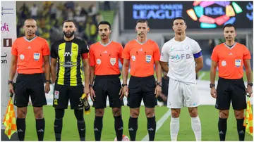Karim Benzema and Cristiano Ronaldo pose for a picture with officials ahead of the Saudi Pro League football match between Al-Ittihad and Al-Nassr at King Abdullah Sports City Stadium. Photo by AFP.