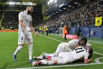 Real Madrid's Spanish midfielder Dani Ceballos (down) celebrates with teammates after scoring his team's late winner