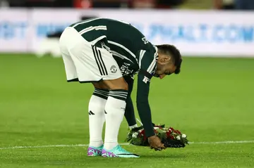 Manchester United captain Bruno Fernandes lays a floral wreath in tribute to the late Bobby Charlton