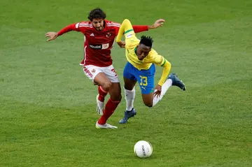 Al Ahly defender Mohamed Hany (L) and Mamelodi Sundowns midfielder Thapelo Maseko clash during the semi-final first leg in Pretoria