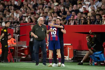 Barcelona's Spanish midfielder Fermin Lopez celebrates scoring his goal with departing coach Xavi Hernandez