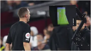 Match Referee David Coote checks the VAR monitor before awarding a penalty to West Ham United during the Premier League match between West Ham United and AFC Bournemouth at London Stadium. Photo by Julian Finney.