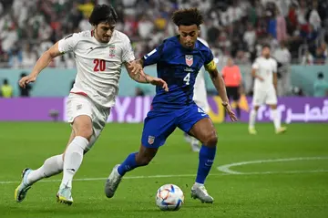 US captain Tyler Adams (4) battles Iran's Sardar Azmoun during Tuesday's Group B clash