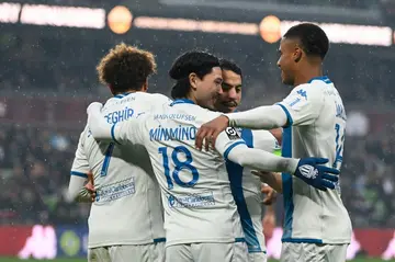 Takumi Minamino (C) celebrates with team-mates after opening the scoring for Monaco against Metz