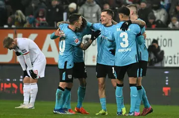 Bayer Leverkusen midfielder Exequiel Palacios (2L) celebrates with his teammates after scoring the winner in a 1-0 win at Augsburg on Saturday