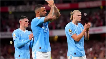 Kyle Walker, Haaland, and Phil Foden applaud fans at the end of the Premier League match at the Emirates Stadium. Photo by John Walton.