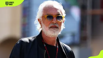 Flavio Briatore walks in the paddock