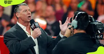 Vince McMahon (l) adresses the crowd.