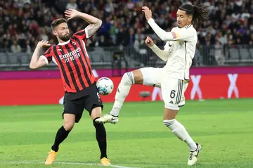 Olivier Giroud (L) battles with Roma's Chris Smalling during AC Milan's 5-2 defeat in Perth