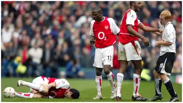 Former Arsenal striker Jose Antonio Reyes lies injured with knee ligament damage after a challenge from Manchester United's Paul Scholes in a past match. Photo: Mike Egerton. 