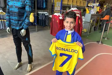 A young fan proudly holds his new Ronaldo jersey at the Al Nassr FC shop in the Saudi capital Riyadh