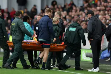 Liverpool manager Jurgen Klopp (R) watches as Diogo Jota is taken off on a stretcher