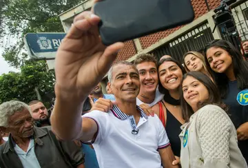 Brazilian senator and football legend Romario takes a selfie with his family after voting in the 2018 elections