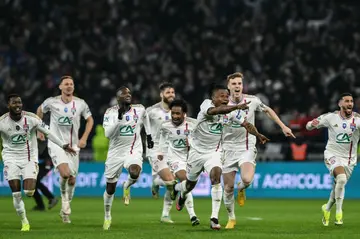 Lyon players celebrate beating Strasbourg on penalties in the French Cup quarter-finals