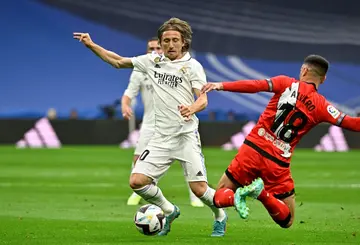 Real Madrid's Croatian midfielder Luka Modric (L) will stay in the Spanish capital for another season
