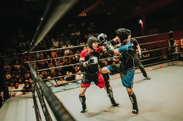 Two fighters fighting inside a ring