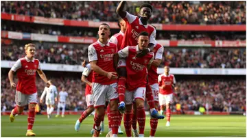 Arsenal players celebrate after scoring during the Premier League match between Arsenal FC and Liverpool FC at Emirates Stadium. Photo by Justin Setterfield.