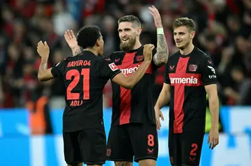 Late show: Bayer Leverkusen's Amine Adli (left), Robert Andrich and Josip Stanisic celebrate the last-gasp draw