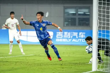Japan's Taichi Yamasaki  celebrates after scoring against Qatar
