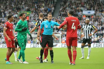 Referee John Brooks sends off Liverpool's Virgil van Dijk (2R)