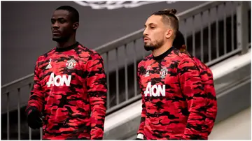 Eric Bailly and Alex Telles look on prior to the UEFA Europa League semi-final match between Manchester United and AS Roma at Old Trafford. Photo by Ash Donelon.