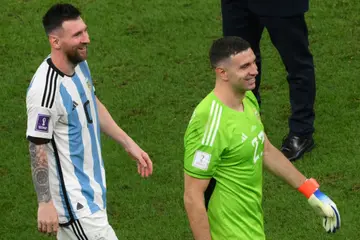Argentina goalkeeper Emiliano Martinez (right) says Lionel Messi (left) is playing better than ever heading into Sunday's World Cup final