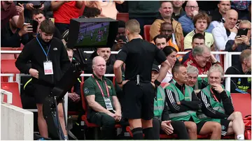 Referee Robert Jones checks the VAR screen for a handball by Cristian Romero during the EPL match between Arsenal FC and Tottenham Hotspur. Photo by Ryan Pierse.