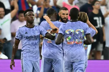 Real Madrid's French forward Karim Benzema celebrates with teammates after converting a penalty in a 2-0 friendly win over Juventus at the Rose Bowl in Los Angeles