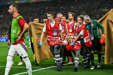 Barnabas Varga (C) is evacuated on a stretcher after getting injured during Hungary's win against Scotland