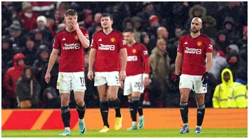 Man United players walk off the pitch dejected. Photo: Martin Rickett.