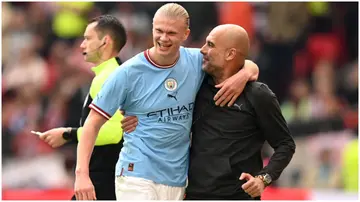 Erling Haaland reacts with Pep Guardiola after being substituted during the Emirates FA Cup Semi-Final match between Manchester City and Sheffield United at Wembley Stadium. Photo by Michael Regan.