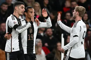 Germany's midfielder Kai Havertz (L) celebrates scoring for his country against England