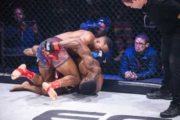 Peace Nguphane lands a blow on Mark Kamba while he was grounded at EFC 105.