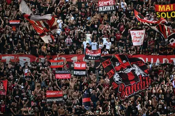 Milan fans hymned their Serie A title before kick off against Udinese and then endured an emotional roller coaster in the first half