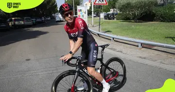 Dave Brailsford rides a bicycle on a street during Team INEOS' rest day.