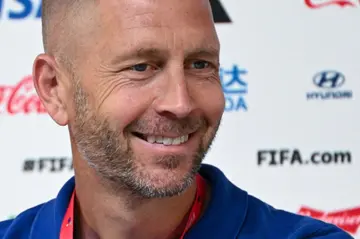 Gregg Berhalter smiles during a press conference in Qatar on the eve of the 2022 World Cup football match between the Netherlands and USA