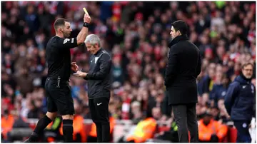 Referee Tim Robinson shows a yellow card to Mikel Arteta during the Premier League match between Arsenal FC and Brighton & Hove Albion at Emirates Stadium. Photo by Richard Heathcote.