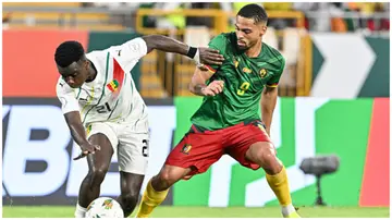 Sekou Sylla fights for the ball with Frank Magri during the Africa Cup of Nations 2023 group C football match between Cameroon and Guinea. Photo: Issouf Sanogo.