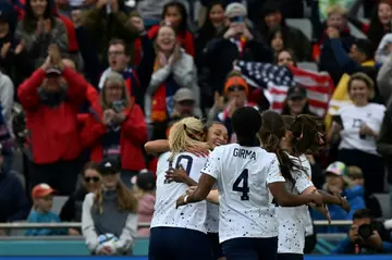 USA forward Sophia Smith is mobbed by her  teammates after scoring