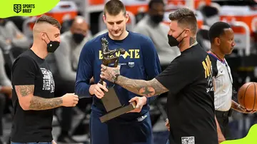 Nikola Jokic accepts congratulations from his brothers