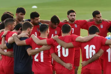 Iran's players gather in a huddle during a World Cup training session