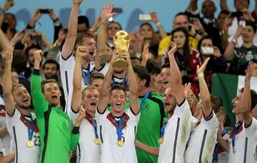 Germany defender Erik Durm (C) holding the World Cup. Durm announced his retirement from football on Wednesday