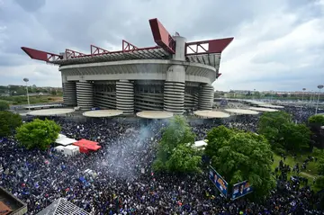 Inter Milan supporters celebrate their team winning the Serie A title outside the San Siro