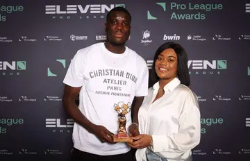 Paul Onuachu poses with one of the awards he won last season with Genk.