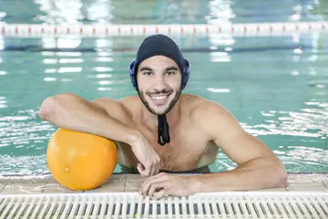 Water polo player holding a ball