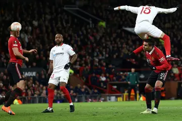 Two late Manchester United own goals handed Sevilla a 2-2 draw at Old Trafford