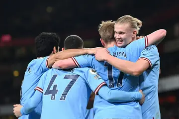 Manchester City striker Erling Haaland (R) celebrates with teammates. The Norwegian is on track to smash the Premier League single-season goalscoring record