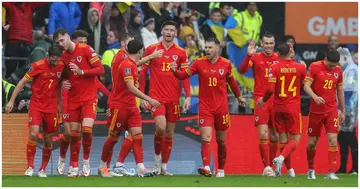 Wales players celebrate during the FIFA World Cup 2022 play-off final qualifier football match against Ukraine at the Cardiff City Stadium. Photo by Geoff Caddick.