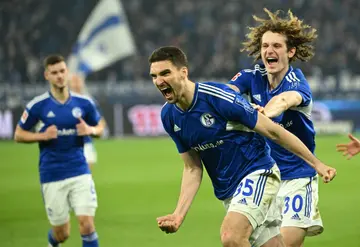 Marcin Kaminski celebrates scoring Schalke's fifth goal pursued by happy tam-mate Alex Kral