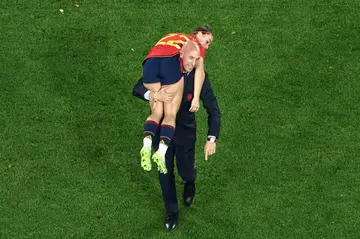 Spanish football federation chief Luis Rubiales carries player Athenea del Castillo after Spain won the Women's World Cup in Australia